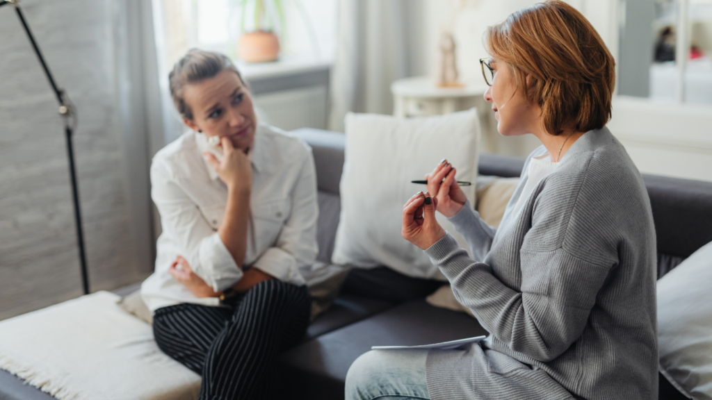 Two women talking on a couch during individual counselling for anxiety in Calgary.