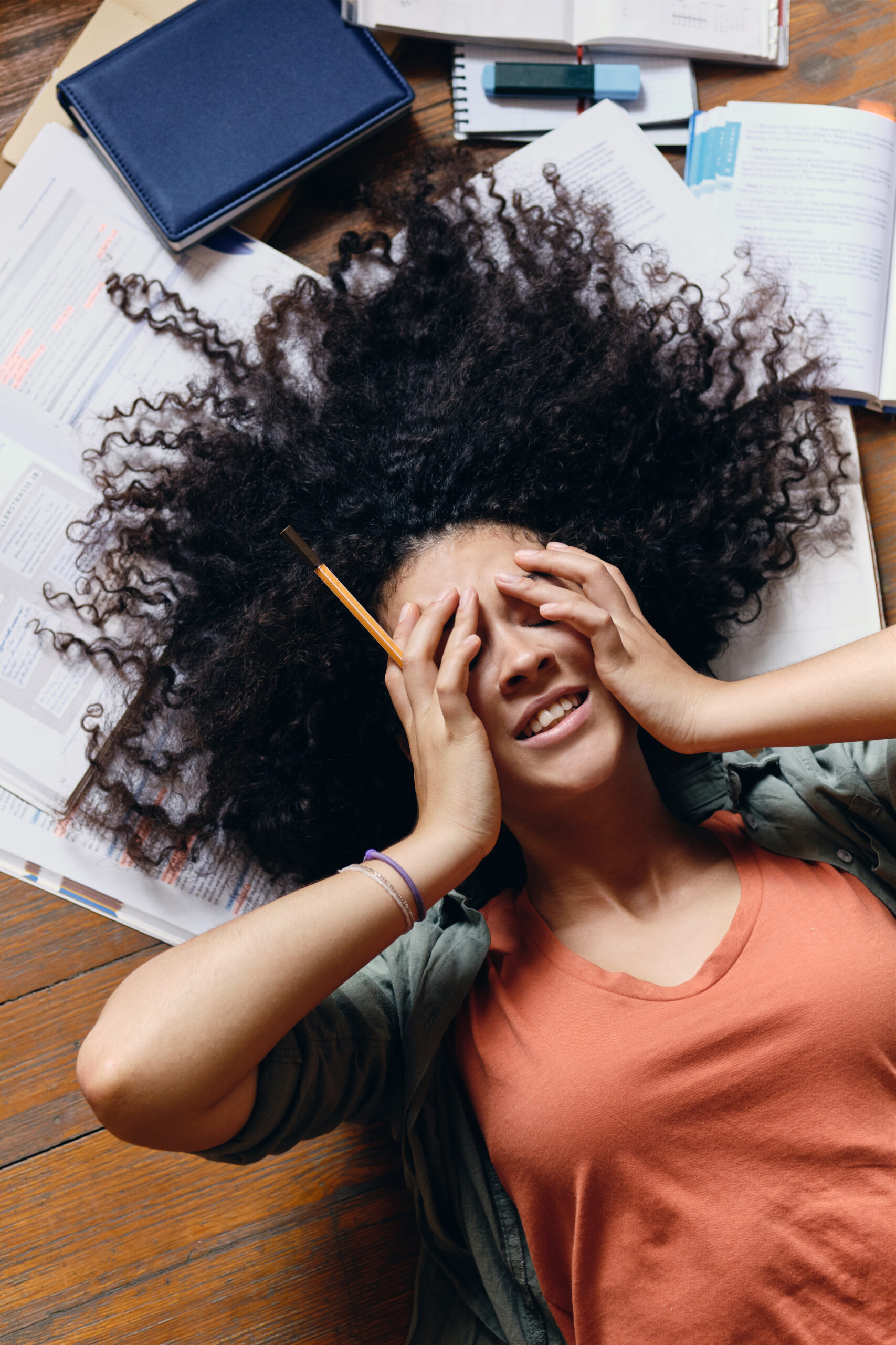 A young woman with undiagnosed ADHD is feeling overwhelmed by her homework.