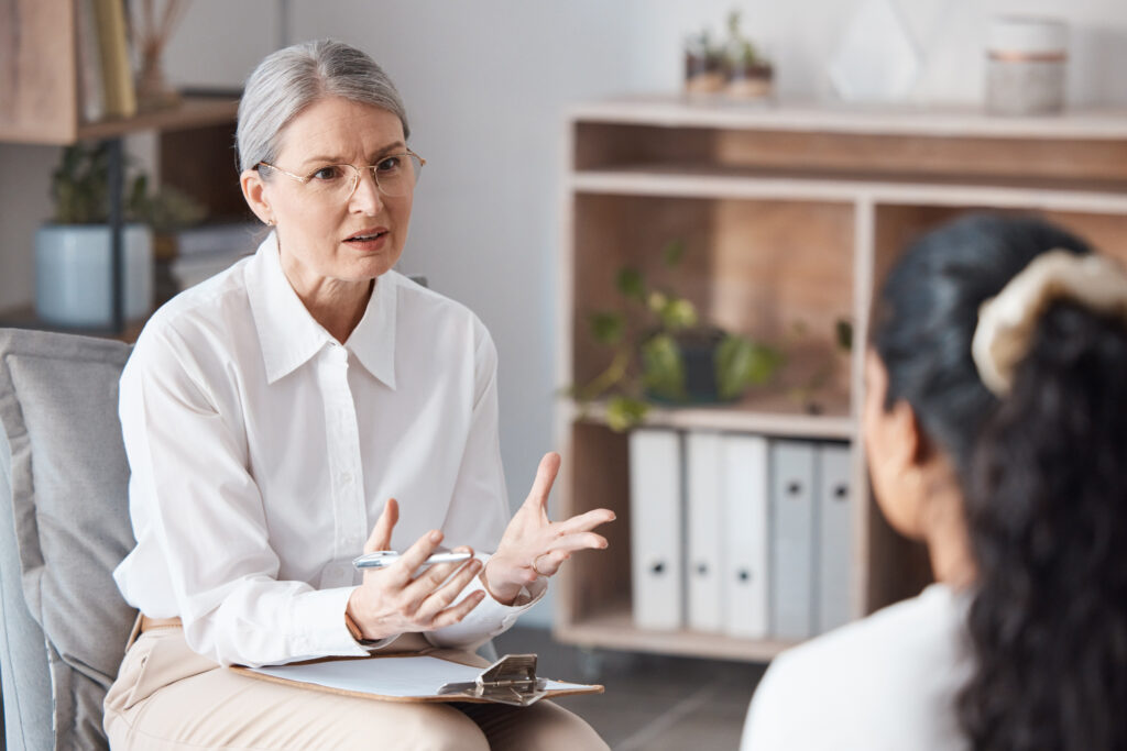 A mature woman therapist discusses the results of her client's ADHD assessment.
